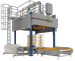 Industrial packaging machine with boxes on a conveyor belt against a black background