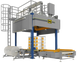 Industrial packaging machine with boxes on a conveyor belt against a black background
